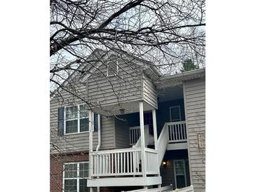 Exterior view of a two-story condo with a balcony and stairs at , Roswell, GA 30076