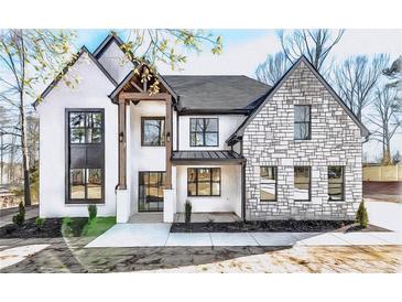 Stunning two-story home features stone and white exterior at 1254 Prospect Rd, Lawrenceville, GA 30043