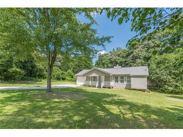 Charming single-story home with a covered front porch and large front yard at 6226 Pine Ln, Douglasville, GA 30135