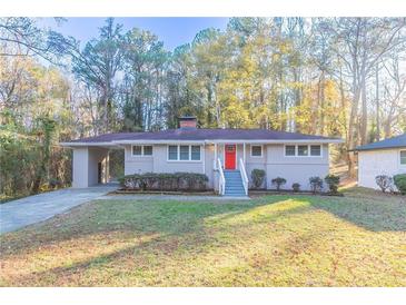 Charming ranch home with red door and well-manicured lawn at 2836 Hedgewood Nw Dr, Atlanta, GA 30311