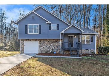 Newly renovated blue house with stone accents and a large yard at 100 Spicewood Ct, South Fulton, GA 30349