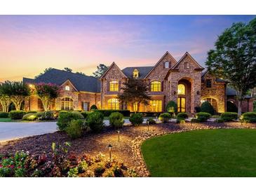 Elegant stone house with manicured landscaping and a charming driveway at 6206 Zell Miller Nw Path, Acworth, GA 30101