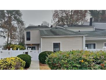 Updated townhome with neutral exterior and a well-manicured front yard at 2683 Meadowlawn Se Dr, Marietta, GA 30067