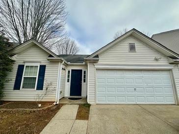 House exterior featuring a two-car garage and a well-maintained front yard at 105 Holly Mill Village Dr, Canton, GA 30114