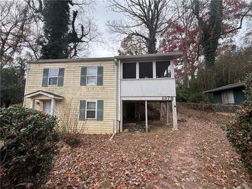 Two-story house with screened porch and yard at 1378 Hawthorne Way, Atlanta, GA 30344