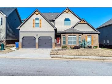 Two-story house with two-car garage and landscaping at 1909 Weatherstaff Ln, Mcdonough, GA 30253