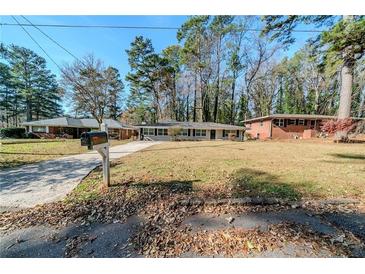 Ranch style home with a spacious yard and driveway at 1471 Midview Dr, Decatur, GA 30032