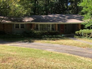 Brick ranch house with a large yard and driveway at 138 Le Brun Ne Rd, Atlanta, GA 30342