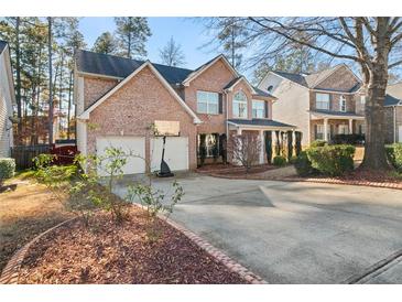 Brick two-story house with a two-car garage and a basketball hoop at 250 Windsor Way, Fairburn, GA 30213