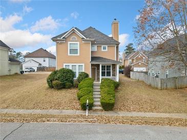 Two-story house with light brown siding, stone accents, and a landscaped front yard at 3050 Raven Trc, Fairburn, GA 30213