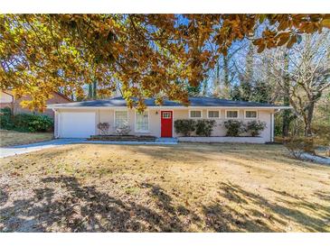 Ranch style home with red front door, attached garage, and well-manicured lawn at 2330 Dorsey Ave, Atlanta, GA 30344