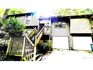 Two-story house with wood siding, a stairway, and attached two-car garage at 145 Ridge Way, Roswell, GA 30076