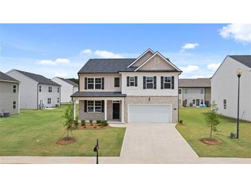 Two-story house with a neutral color scheme and a two-car garage at 120 Bonito Trl, Covington, GA 30016