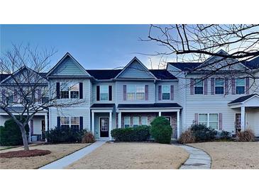 Inviting 2-story townhome with charming facade and landscaping at 4146 Shoals Pt, Union City, GA 30291