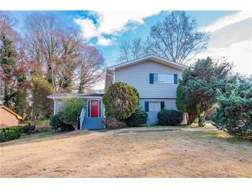 Two-story house with gray siding, red door, and landscaping at 4557 Greenleaf Sw Cir, Atlanta, GA 30331