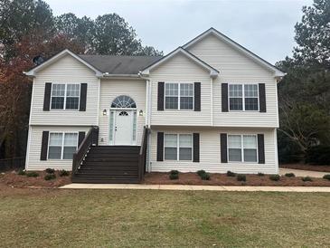 Two story house with brown accents and landscaping at 360 Chestnut Dr, Covington, GA 30016
