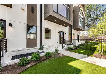 Modern townhome with white and brown exterior, landscaped lawn, and private entrance at 1099 North Ne Ave # 11, Atlanta, GA 30307