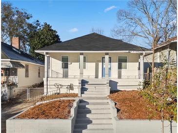 Charming bungalow with front porch, freshly landscaped yard, and updated exterior at 1024 Herndon Nw St, Atlanta, GA 30318