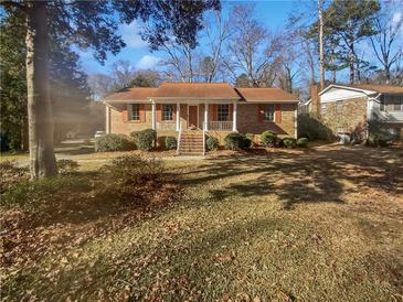 Brick ranch house with a front yard and steps leading to the entrance at 6041 Morrow Cv, Morrow, GA 30260