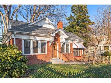 Brick home with a charming front porch and well-maintained lawn at 1015 Deckner Sw Ave, Atlanta, GA 30310
