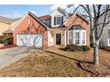Brick two-story house with attached garage and landscaping at 6469 Alder Ln, Norcross, GA 30093