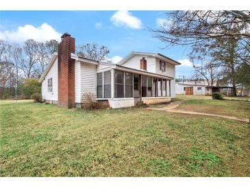 Ranch style home with screened porch and large backyard at 25 Sixth St, Villa Rica, GA 30180