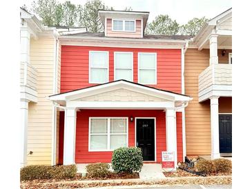 Two-story red house with white columns and landscaping at 1797 Brookside Lay Cir, Norcross, GA 30093