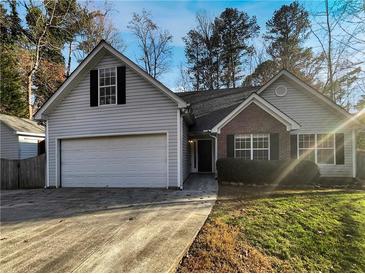 Two-story house with gray siding, brick accents, and a two-car garage at 5916 Ohara Dr, Stone Mountain, GA 30087