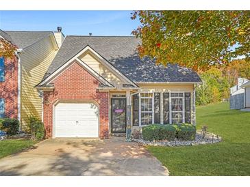 Brick townhouse with attached garage and landscaped front yard at 9569 Lakeview Cir, Union City, GA 30291