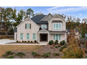 Two story house with gray brick, three car garage, and landscaped lawn at 440 Parkbrook Way, Canton, GA 30114