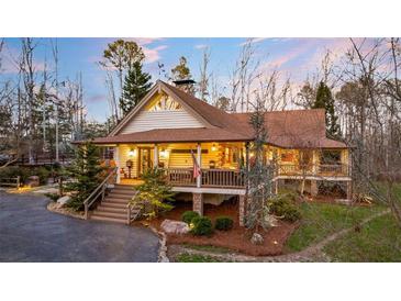 Charming log home with expansive wrap-around porch at 697 Hillwood Ct, Dacula, GA 30019