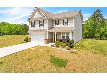Two-story house with attached garage and landscaped front yard at 4929 Calgary Dr, Douglasville, GA 30135