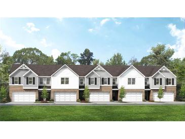 Five townhouses with attached garages and manicured lawns at 223 Sanctuary Dr, Mcdonough, GA 30253