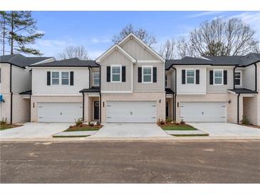 Two-story townhome with attached garage and modern facade at 320 Shine Dr, Stockbridge, GA 30281