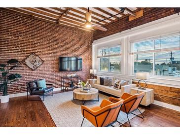 Spacious living area with exposed brick, hardwood floors, and large windows at 150 Walker Sw St # 5, Atlanta, GA 30313