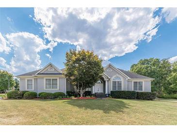 Ranch style home with gray siding, landscaping, and a spacious lawn at 5170 Stone Croft Trl, Atlanta, GA 30331