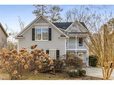 Two-story house with gray siding, white trim, and a charming front porch at 242 Ivy Glen Cir, Avondale Estates, GA 30002