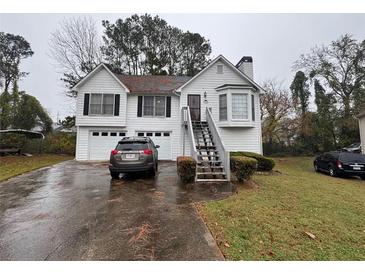 Two-story house with attached garage and a front yard at 629 Lockhart Ct, Marietta, GA 30066