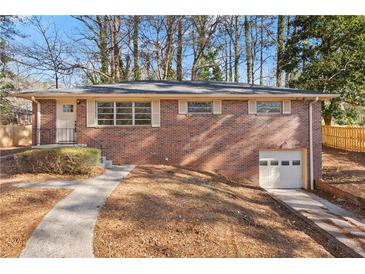 Brick ranch house with attached garage and landscaped yard at 2299 Beaver Creek Se Rd, Smyrna, GA 30080