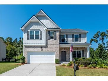 Two-story house with gray siding and a white garage door at 6510 Boulder Rdg, Cumming, GA 30028