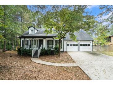 Charming single story home with a two car garage and manicured lawn at 372 Rustic Ridge Cir, Lawrenceville, GA 30043