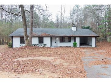 White ranch house with black window frames and attached garage at 3436 Lake Monroe Rd, Douglasville, GA 30135