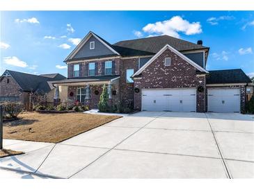Brick two-story house with three car garage and landscaped yard at 1178 Fort Marcy Park, Lawrenceville, GA 30044