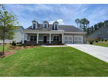 Two-story house with brick accents, a covered porch, and a three-car garage at 1999 Gladys Ct, Marietta, GA 30064