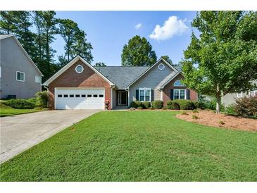 Brick ranch house with attached garage and landscaped lawn at 2712 Windsor Ct, Kennesaw, GA 30144