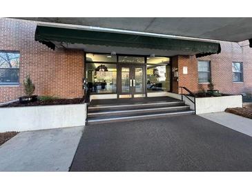 Brick building entrance with awning, steps, and landscaping at 2965 Pharr Court South Nw # 815, Atlanta, GA 30305