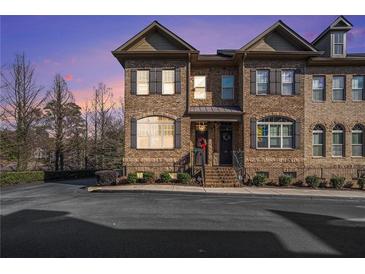 Brick front exterior of townhome with steps leading to covered entry at 913 Telfair Close # 13, Atlanta, GA 30350