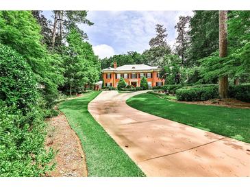 Brick home with long driveway, lush landscaping, and a grand facade at 3370 Habersham Nw Rd, Atlanta, GA 30305