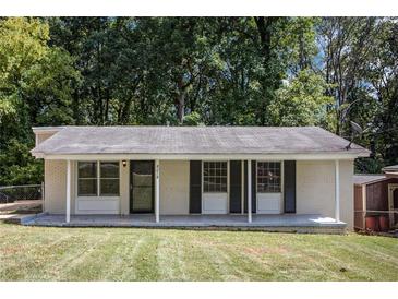 Ranch style home with a covered porch and landscaped yard at 4218 Tara Dr, Forest Park, GA 30297