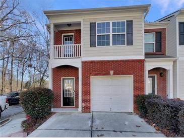 Brick front exterior of charming townhome with attached garage at 2491 Emma Way, Lawrenceville, GA 30044